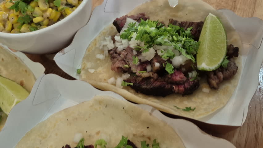 Hand sqeeze lime juice on birria beef taco mexican food 4k