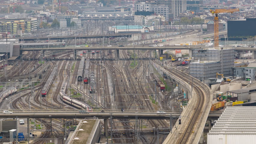 cloudy day zurich city industrial district train station railroad traffic aerial panorama 4k timelapse switzerland