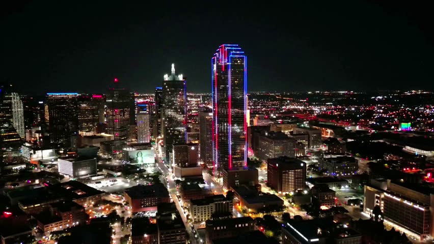 Aerial view of Dallas skyline above busy nighttime street