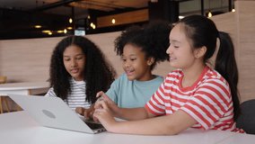 Happy group of Asian, Hispanic, and Caucasian children learning online together with laptop, showing diversity, teamwork, and fun education at home. - Powered by Shutterstock - Get 15% off with code: PIKWIZARD15
