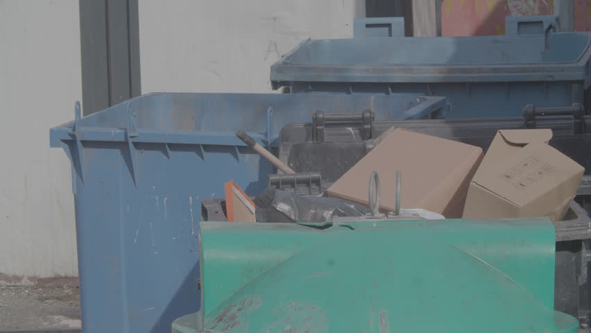 Blue and green dump truck with cardboard boxes