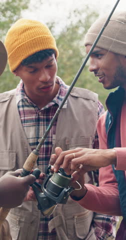 Fishing, talking and help with friends outdoor for adventure, casting advice and bonding. Fisherman season, reel gear discussion and camping vacation with group of people in nature for rod equipment