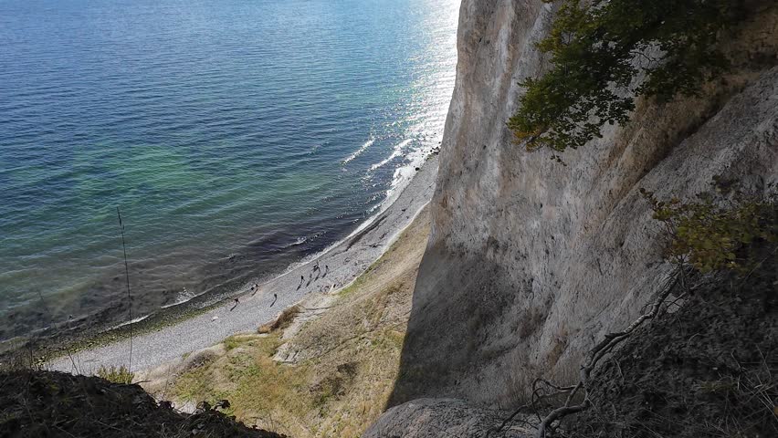 Autumn Aerial Video of Chalk Cliffs and Baltic Sea Coast at Jasmund National Park, Rügen Island. The video shows colorful forest landscapes, white limestone cliffs and the blue water of the Baltic Sea