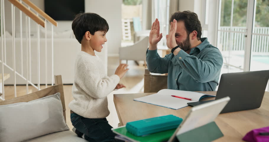 Studying, high five and father with son in family home, teaching problem solving and excited for finish. Homework, man and child celebrate with technology for learning, education support and winning.