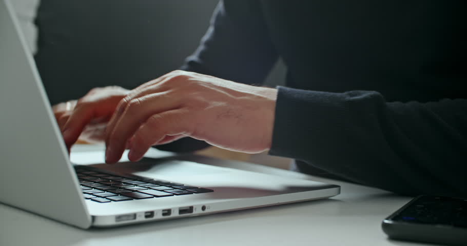 Close-up of person typing on laptop as green holographic padlock icon and “Access allowed” text appear, symbolizing successful login, data protection, and system security.