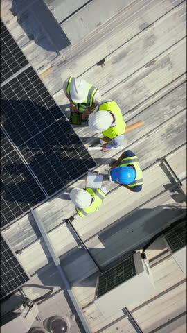 Drone, architect and people on building, solar panels and property development with renewable energy. Outdoor, architecture and colleagues with sustainable power, aerial view and civil engineering