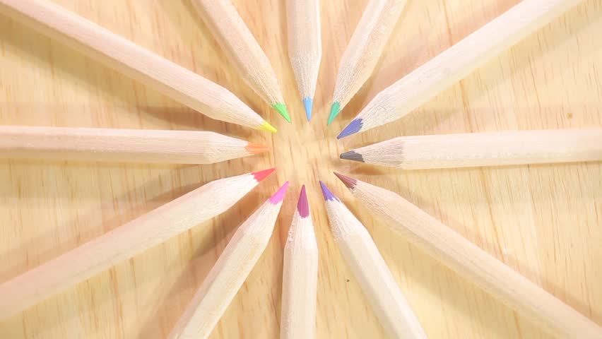 A stack of colored pencils spinning in circles - looping