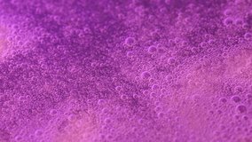 Macro view of countless pink microbubbles swirling and rising through a shimmering liquid, forming a foam texture. Ideal 4K footage for beauty, cosmetics, spa, science visuals, and creative backdrops. - Powered by Shutterstock - Get 15% off with code: PIKWIZARD15