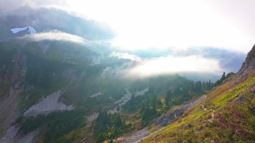 Scenic view of clouds flying through the majestic Sahale Arm, along the Cascade Pass Trail in North Cascades National Park