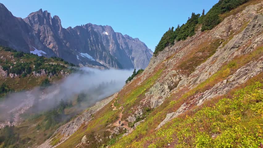 Scenic view of clouds flying through the majestic Sahale Arm, along the Cascade Pass Trail in North Cascades National Park