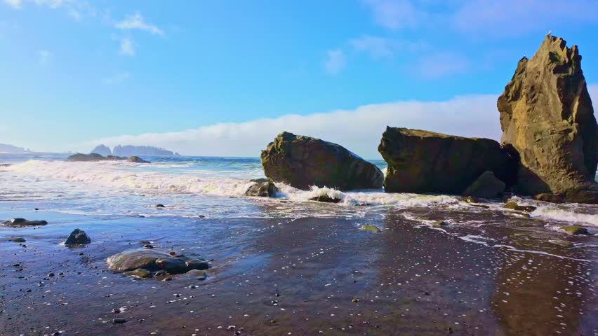 A scenic view of the iconic Hole-In-The-Wall sea stack and cliff on the rugged Pacific Coast of Olympic National Park