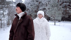 Happy mature woman playfully approaching and embracing her husband from behind. Loving senior couple enjoying a walk in a beautiful snowy forest - Powered by Shutterstock - Get 15% off with code: PIKWIZARD15