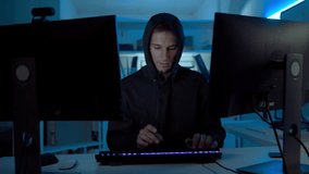 Professional cybersecurity engineer coding software to prevent scam and hacking attacks in dark cyber office at night, illustrating data protection, digital defense, and online security. - Powered by Shutterstock - Get 15% off with code: PIKWIZARD15