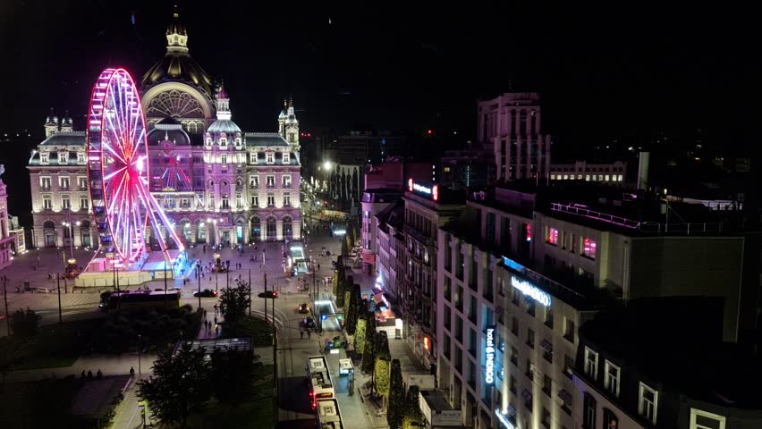 Evening time-lapse over Antwerp city, bustling streets with cars and pedestrians, cinematic aerial view capturing urban energy and city lights.