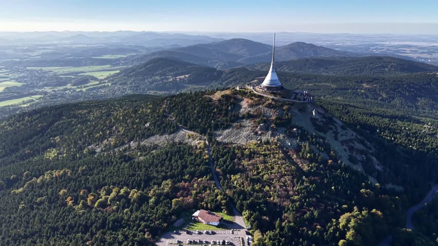 Breathtaking Aerial View of a Scenic Tower Nestled Among Lush Green Hills and Nature