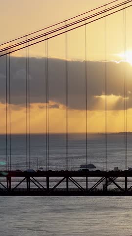 Sunset Sky Over 25 Of April Bridge At Lisbon In Lisbon District Portugal. Sunset Downtown. Freeway Road Landscape. 25 Of April Bridge At Lisbon In Portugal. Public Transport Scenery.