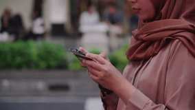 Young asian muslim woman holding credit card using a digital mobile device and buying online and internet shopping. Close up of asian female hand typing card number on smartphone. Lifestyle concept. - Powered by Shutterstock - Get 15% off with code: PIKWIZARD15