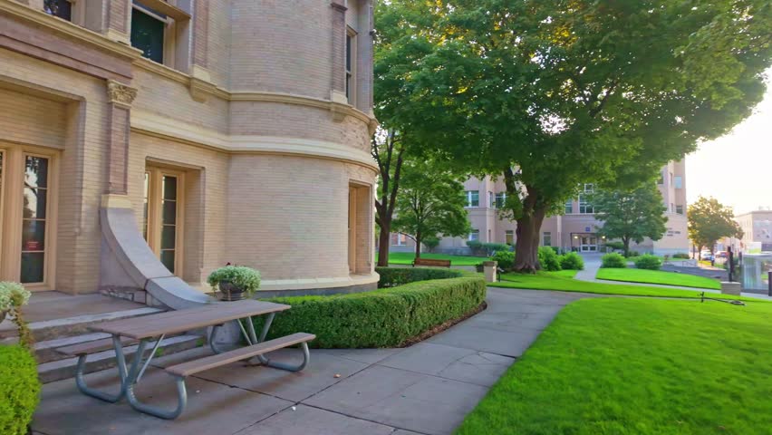 A beautiful scenic view of the Spokane County Courthouse, bathed in the soft, warm light of sunrise