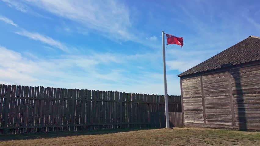 A scenic view of Fort Vancouver, a former fur trading post, showcasing its reconstructed stockade and historical buildings under a clear sky