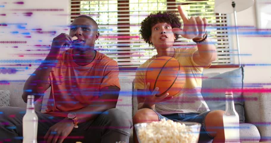 Two men eating popcorn gripping basketball while glitch sweeping gaming reaction to key moment. Friendship, leisure, entertainment, modern, vibrant, excitement, casual