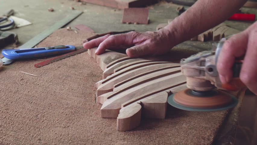 Slow motion of a professional technician using a wood sander.