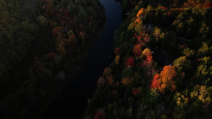 Aerial looking down on Muskoka River in fall with colorful leaves in Ontario Canada