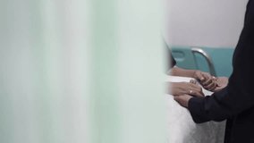 Wife in labor holding and squeezing her husband’s hand in a hospital room, expressing pain and emotional support during childbirth. - Powered by Shutterstock - Get 15% off with code: PIKWIZARD15