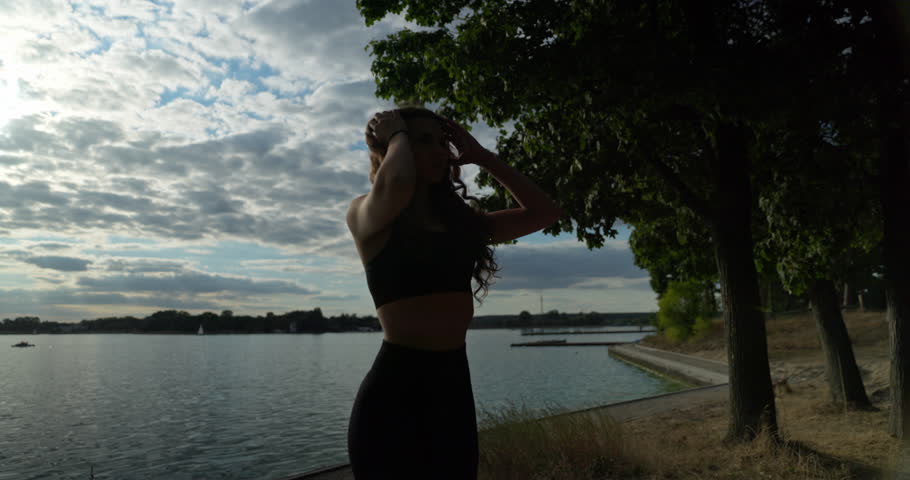 A beautiful silhouette at sunset by the tranquil water, capturing the magic of natures beauty