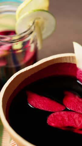 Vertical Video, Hibiscus Drink, Sobolo, Vibrant red drink made from dried hibiscus petals, pineapple peels, ginger, cloves, and sweetened to taste