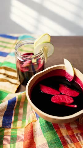 Vertical Video, Hibiscus Drink, Sobolo, Vibrant red drink made from dried hibiscus petals, pineapple peels, ginger, cloves, and sweetened to taste