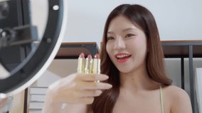Young asian beauty influencer review multiple lipstick shades at home, cosmetic product of content creator on social media and presenting, beauty and care, live streaming makeup tutorial. - Powered by Shutterstock - Get 15% off with code: PIKWIZARD15
