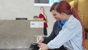 Couple guest check in at hotel with receptionist, staff provide service and support for travel reservation, tourists discussing booking in lobby, receptionist completing check in resort. - Powered by Shutterstock - Get 15% off with code: PIKWIZARD15