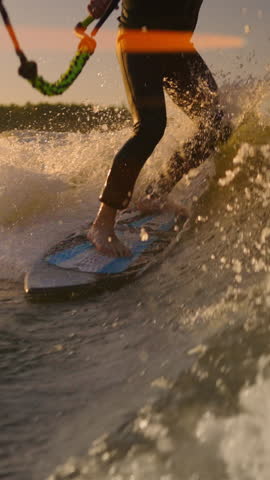 A Dynamic Surfing Adventure: A Rider Balancing Skillfully on a Wakeboard as Waves Crash Around, Showcasing Agility and Thrill at Sunset