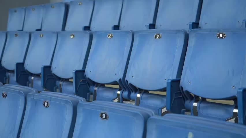 an empty gray-blue stadium, waiting for the football match to begin