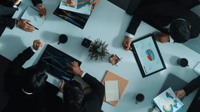 Top view of smart marketing team analyze financial statistic graph and stock market chart from tablet and laptop at meeting table. Group of diverse business people discuss marketing plan. Directorate. - Powered by Shutterstock - Get 15% off with code: PIKWIZARD15