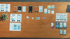 Top view of professional business man looking and choosing Ux Ui design for mobile phone interface. Caucasian software developer thinking about wireframe prototype design at meeting table. Convocation - Powered by Shutterstock - Get 15% off with code: PIKWIZARD15