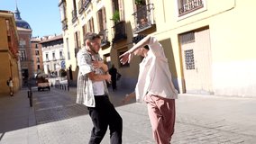 Two talented young male dancers performing a contemporary and expressive dance routine on a sunny cobblestone street, showcasing their fluid movements and artistic collaboration in an urban setting - Powered by Shutterstock - Get 15% off with code: PIKWIZARD15