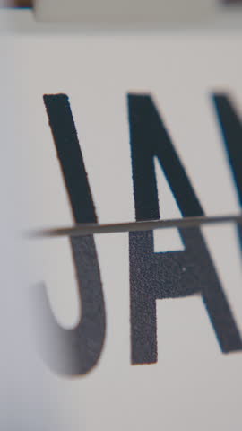 Close-up shot of month field on a flip calendar rapidly changing