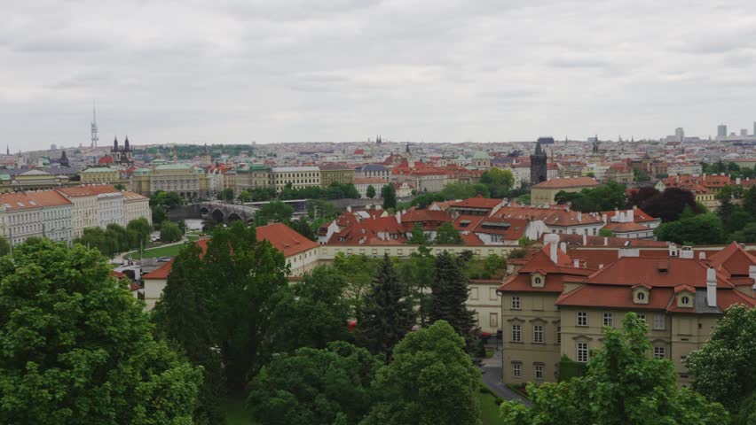 Summer cityscape of Prague with red rooftops.
