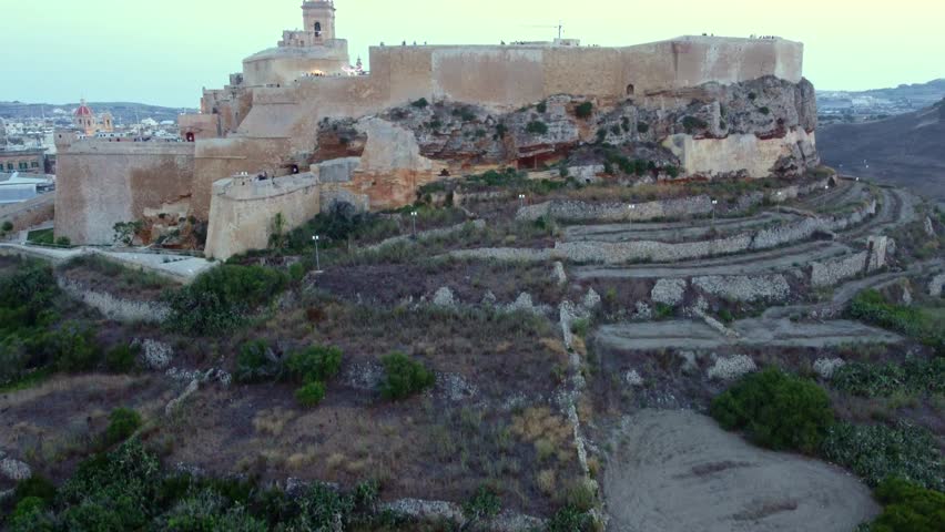 4K drone ascends to reveal the illuminated Citadella in Rabat, Gozo during the Light Festival: glowing ramparts, cathedral domes and festival colors unfold;ideal for travel, cultural and promotion