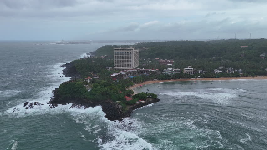 A beautiful hotel stands on the coast of the Indian Oken in Sri Lanka