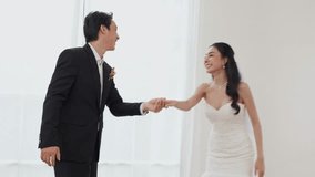 Bride and groom embrace and smile during indoor wedding first dance bright minimalist venue joyful romantic moment with bridal gown and tuxedo young bride strapless lace wedding dress smiling holding - Powered by Shutterstock - Get 15% off with code: PIKWIZARD15