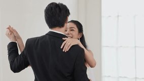 Bride and groom embrace and smile during indoor wedding first dance bright minimalist venue joyful romantic moment with bridal gown and tuxedo young bride strapless lace wedding dress smiling holding - Powered by Shutterstock - Get 15% off with code: PIKWIZARD15