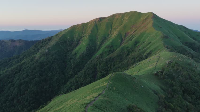 Sunrise light hits ridge trail on Mt. Tsurugi in Shikou, Japan