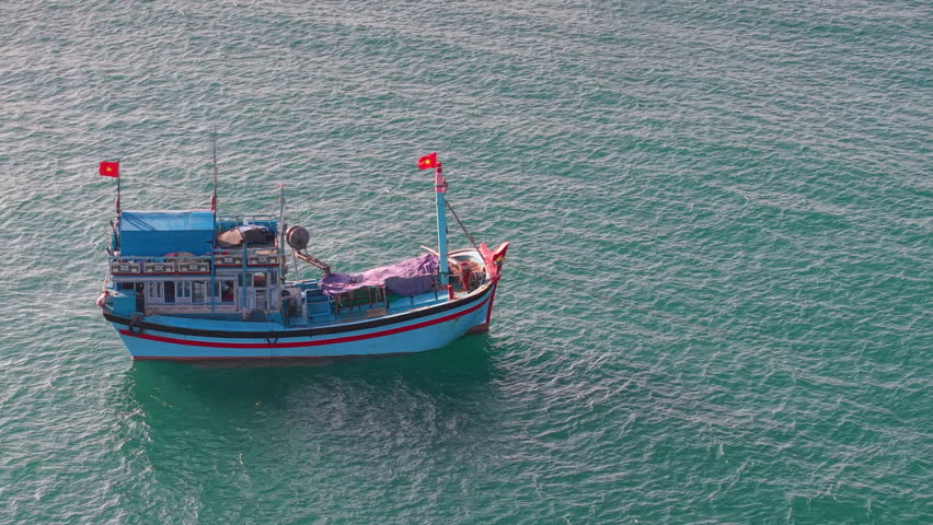 Wooden fishing boat floating offshore in Vietnam, lifestyle of fishermen, tropical seascape and maritime heritage. Traditional vessel symbolizing marine culture, livelihood coastal lifestyle 