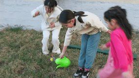Woman and daughter planting and watering flowers in the garden. Family lifestyle, spring outdoor activity and happy bonding time. - Powered by Shutterstock - Get 15% off with code: PIKWIZARD15