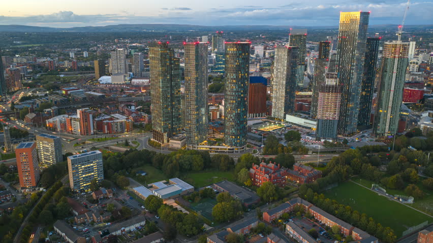 Aerial hyperlapse over Hulme Park towards Deansgate Square, revealing Manchester’s skyline under the evening glow.