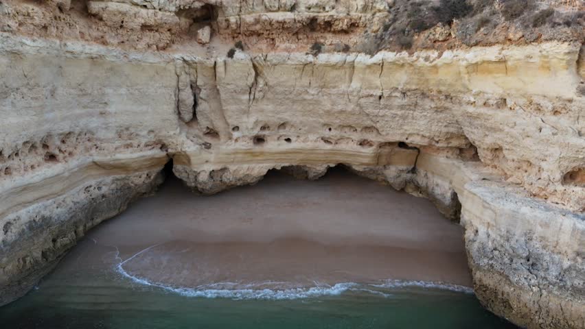 Aerial view by drone of praia da marinha in Algarve, south Region of Portugal. The incredibile cliff and natural arches with an incredible smerald water.