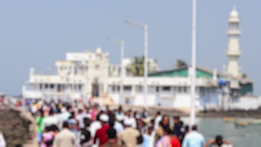 Bokeh view of people visit Haji Ali Dargah in Mumbai, India. Blurred background footage.