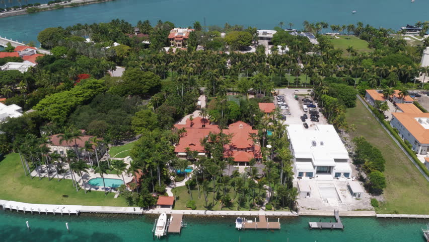 Florida landscape view. Star Island in Miami beach, Florida. Residential buildings in luxury Star island surrounded by sea. Waterfront residential area on Star island, Miami. Tropical landscaping